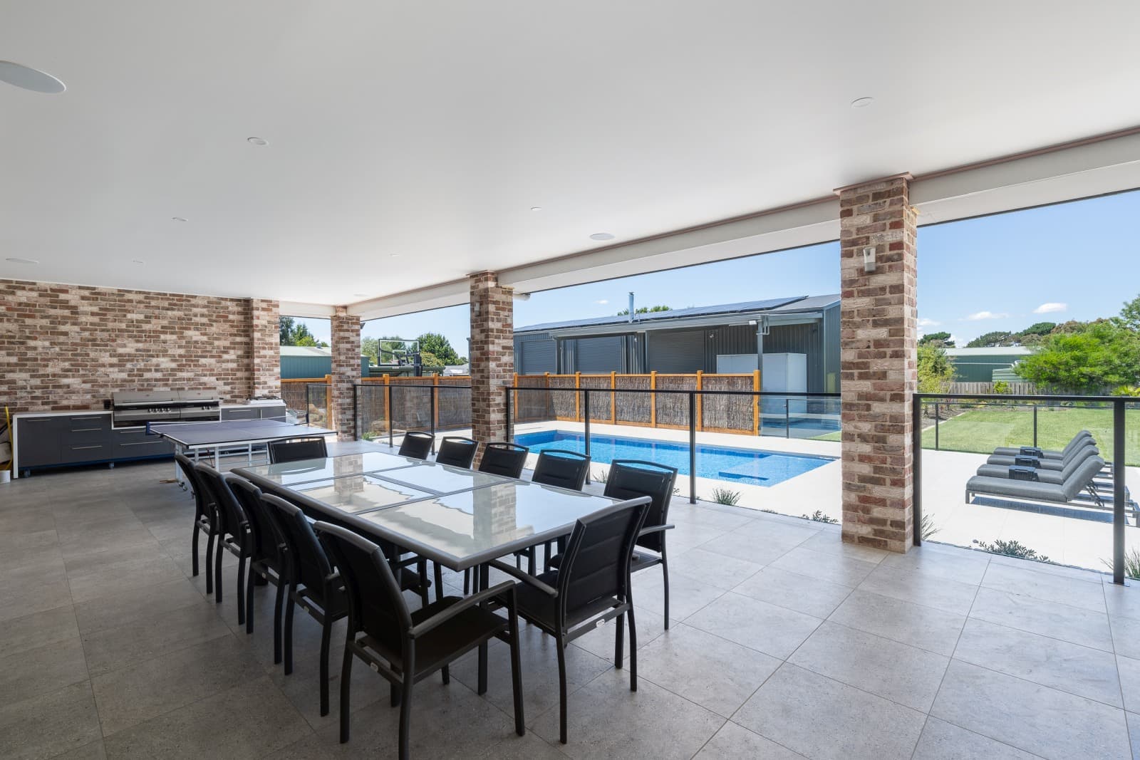 Completed Enchanted concrete pool seen from the home's covered outdoor dining area