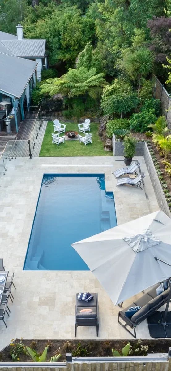 Fibreglass pool set into a landscaped backyard, seen from above