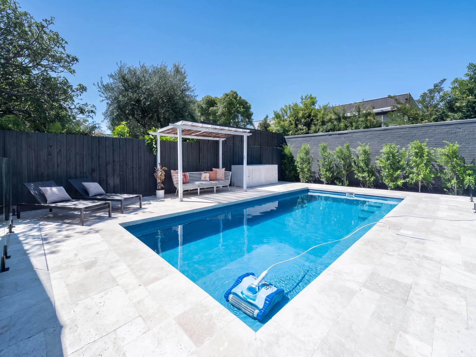 Visual comparison of robotic cleaner in a daytime backyard pool