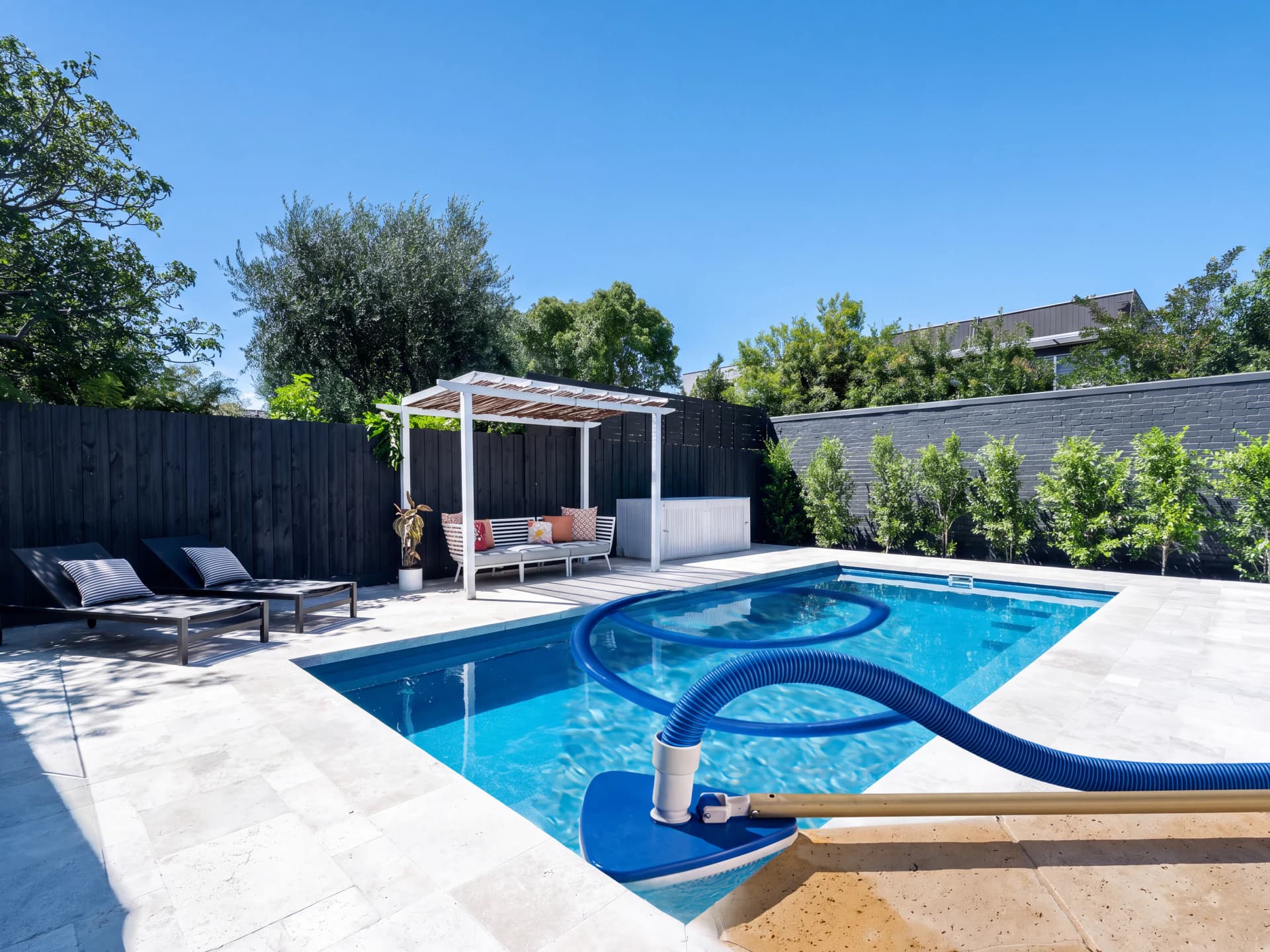 Visual comparison of suction cleaners in a daytime backyard pool