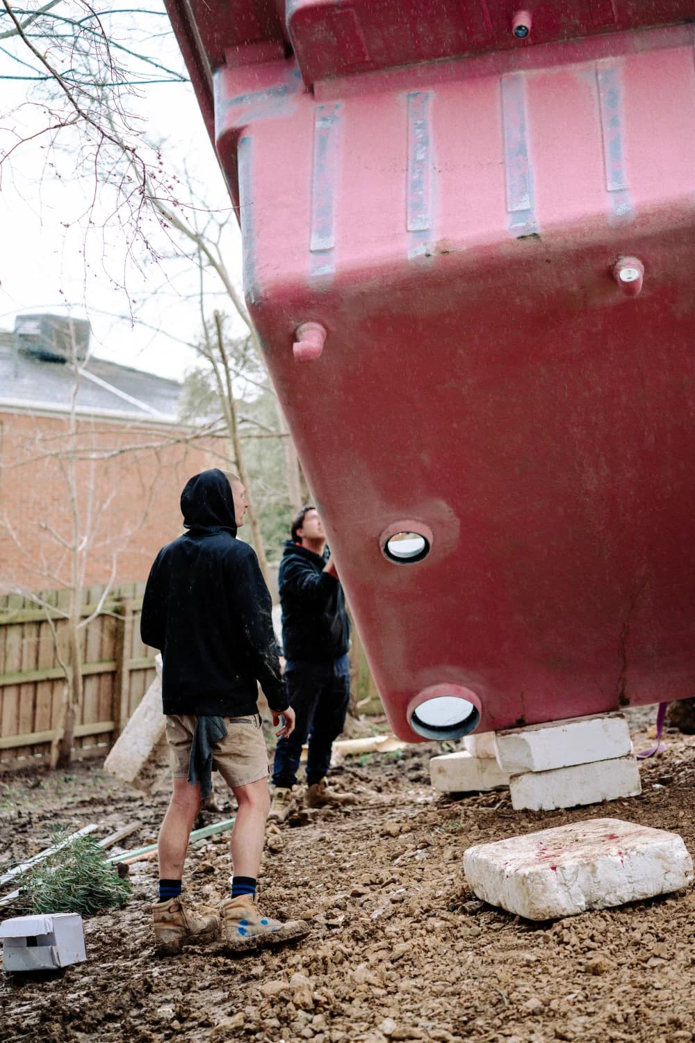Enchanted Pools installers checking the position of a fibreglass pool shell