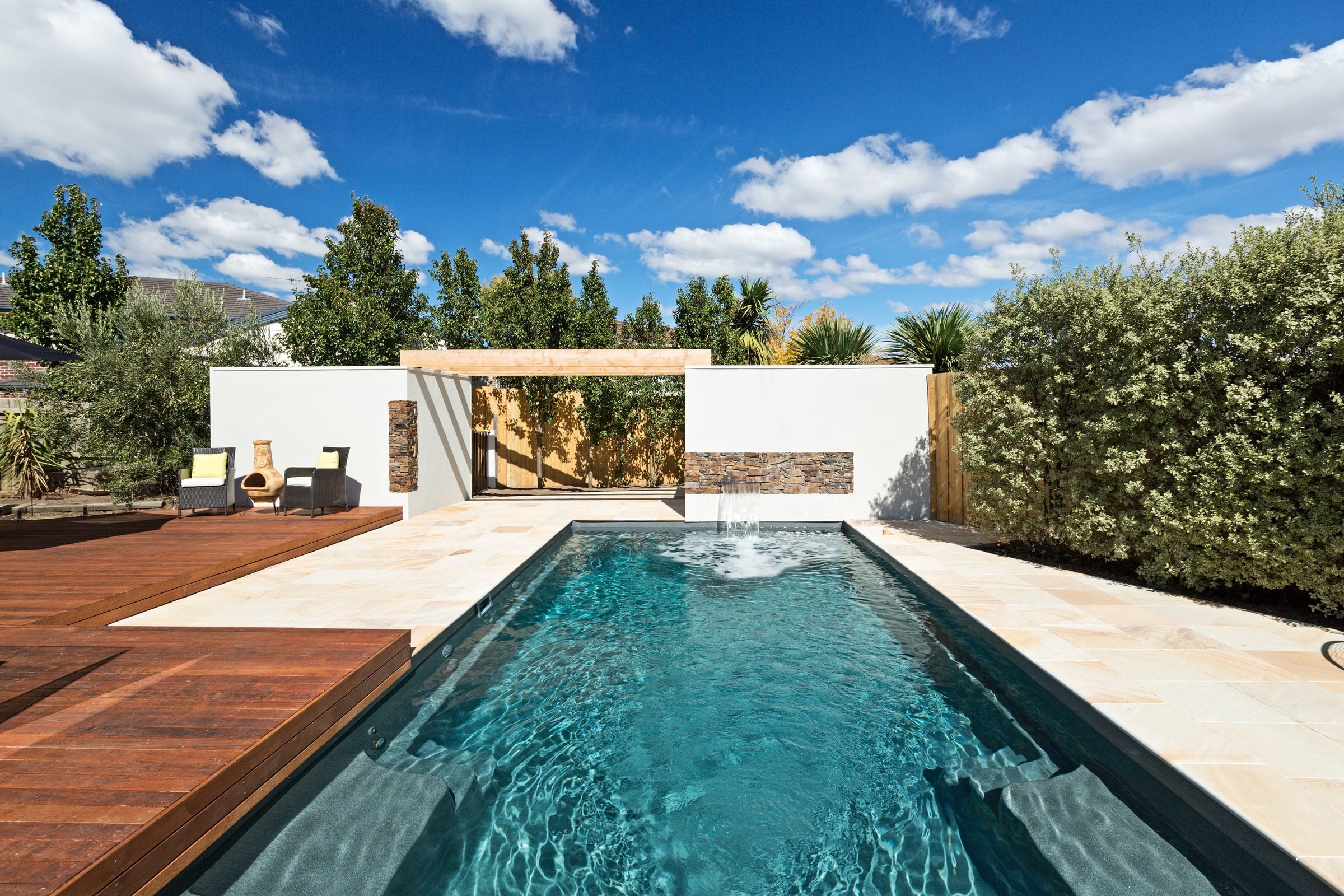 X-Trainer fibreglass pool in a modern garden with a white pavilion
