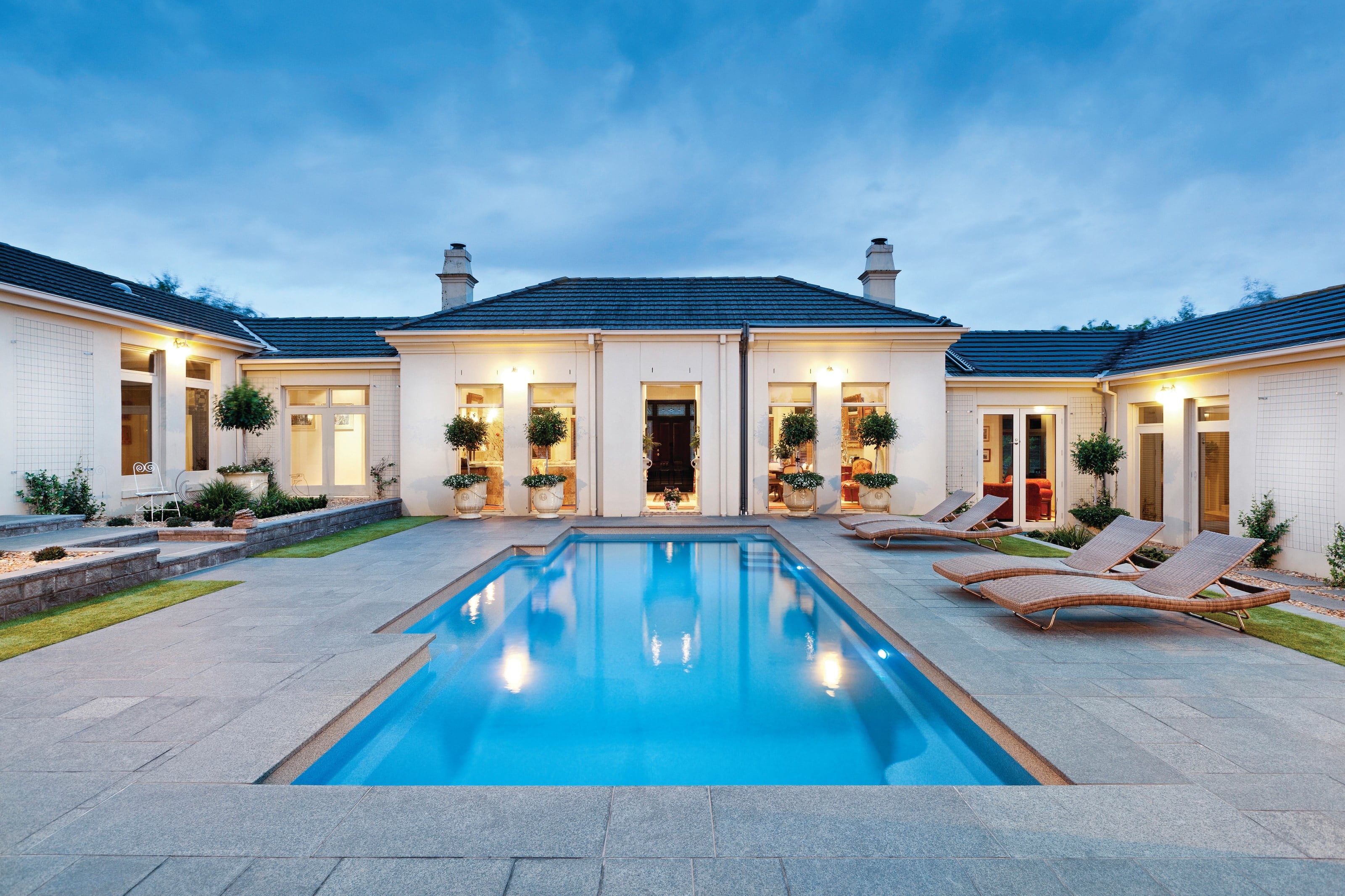 Vogue fibreglass pool centred in a formal paved courtyard