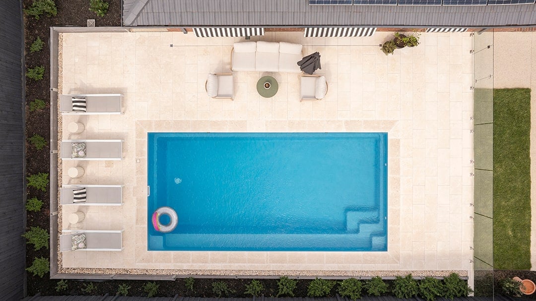 Overhead view of the pool, full-length bench and limestone paving in Rowville