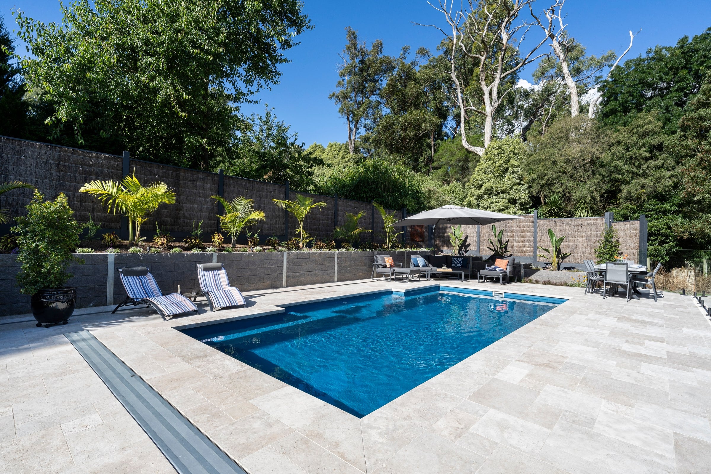 Bluestone-toned fibreglass pool set into the hillside in Emerald