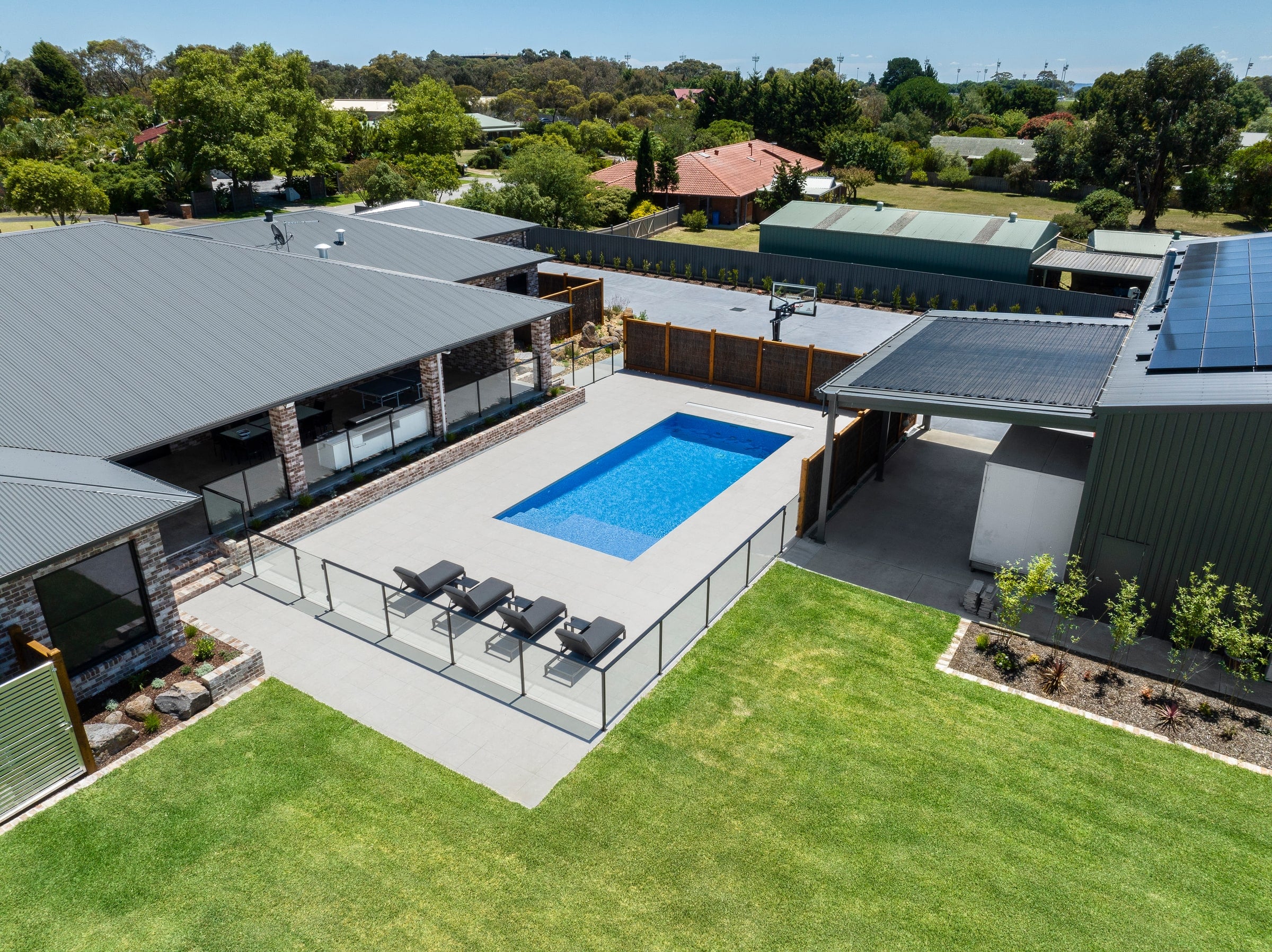 Aerial view of the tiled pool, lawn and outdoor areas in Cranbourne