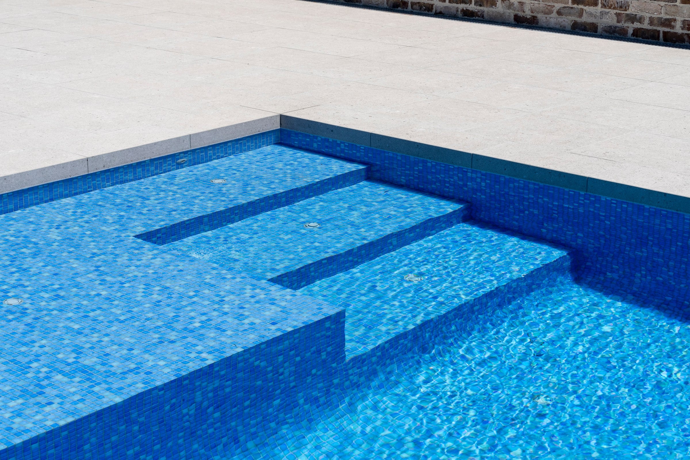 Glass mosaic tiling on the shallow bench and steps in Cranbourne