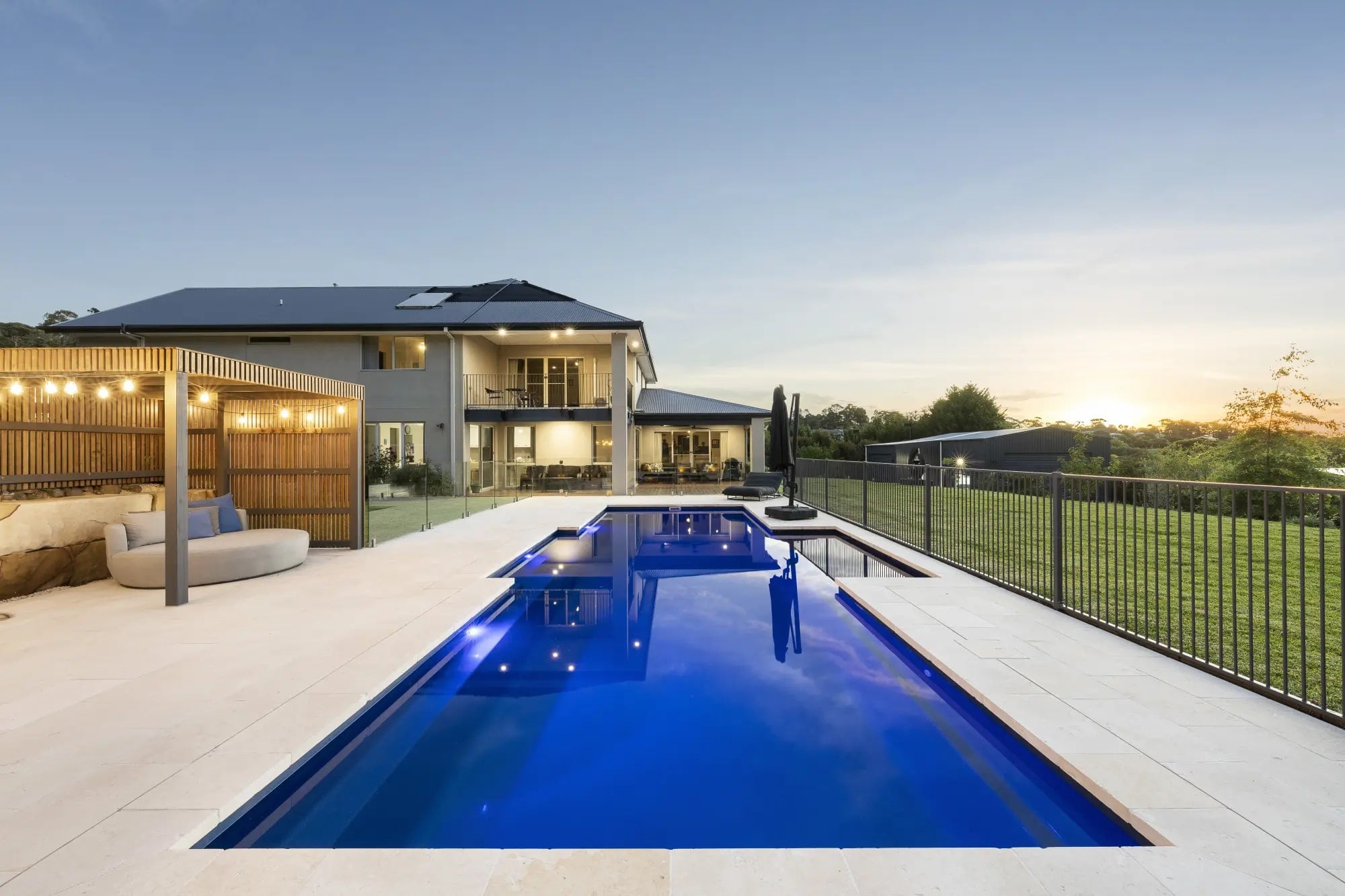 Fibreglass pool and lit home at dusk in Lysterfield South