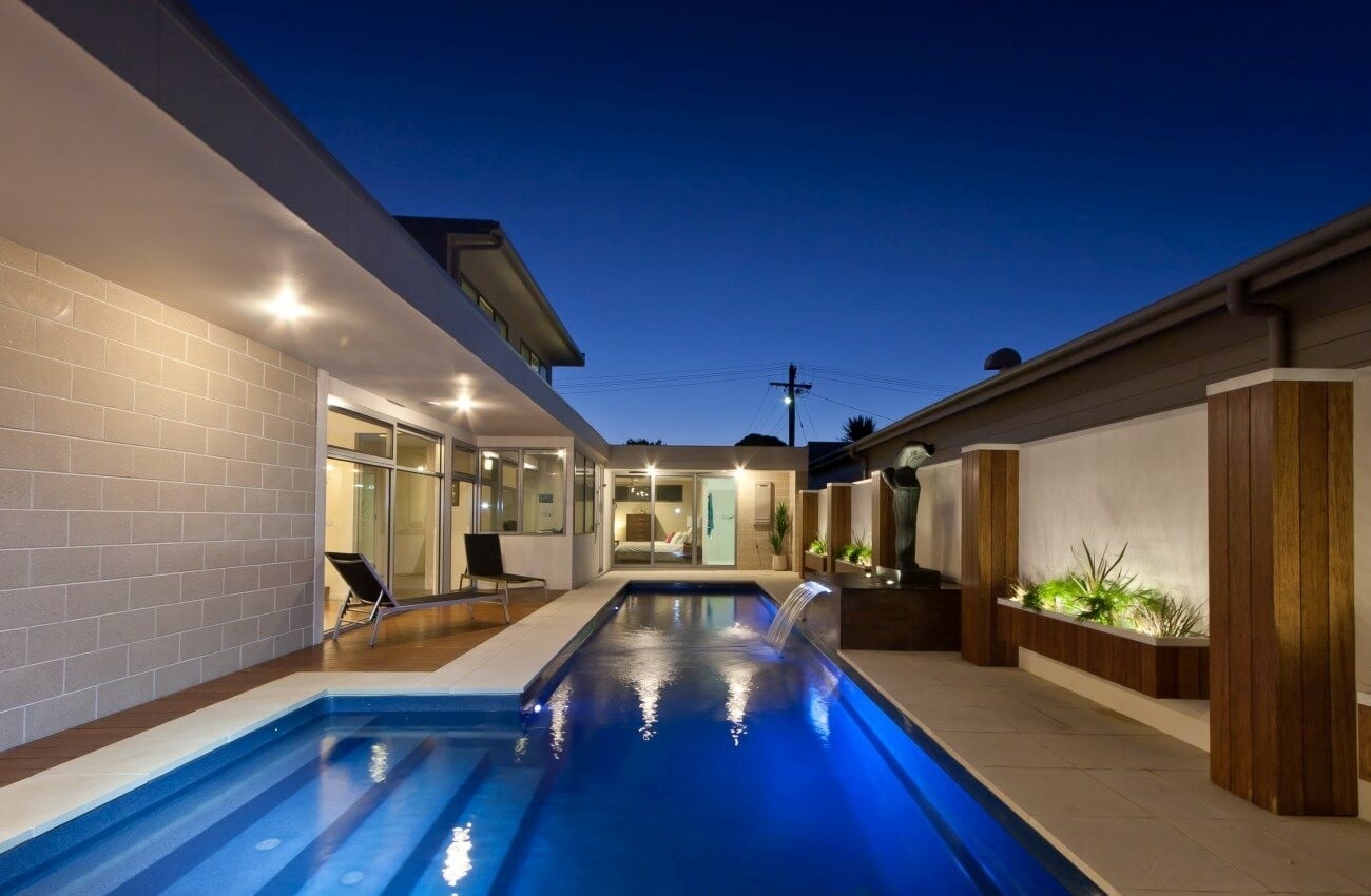 Compass supplier depiction of a Fastlane fibreglass lap pool at dusk