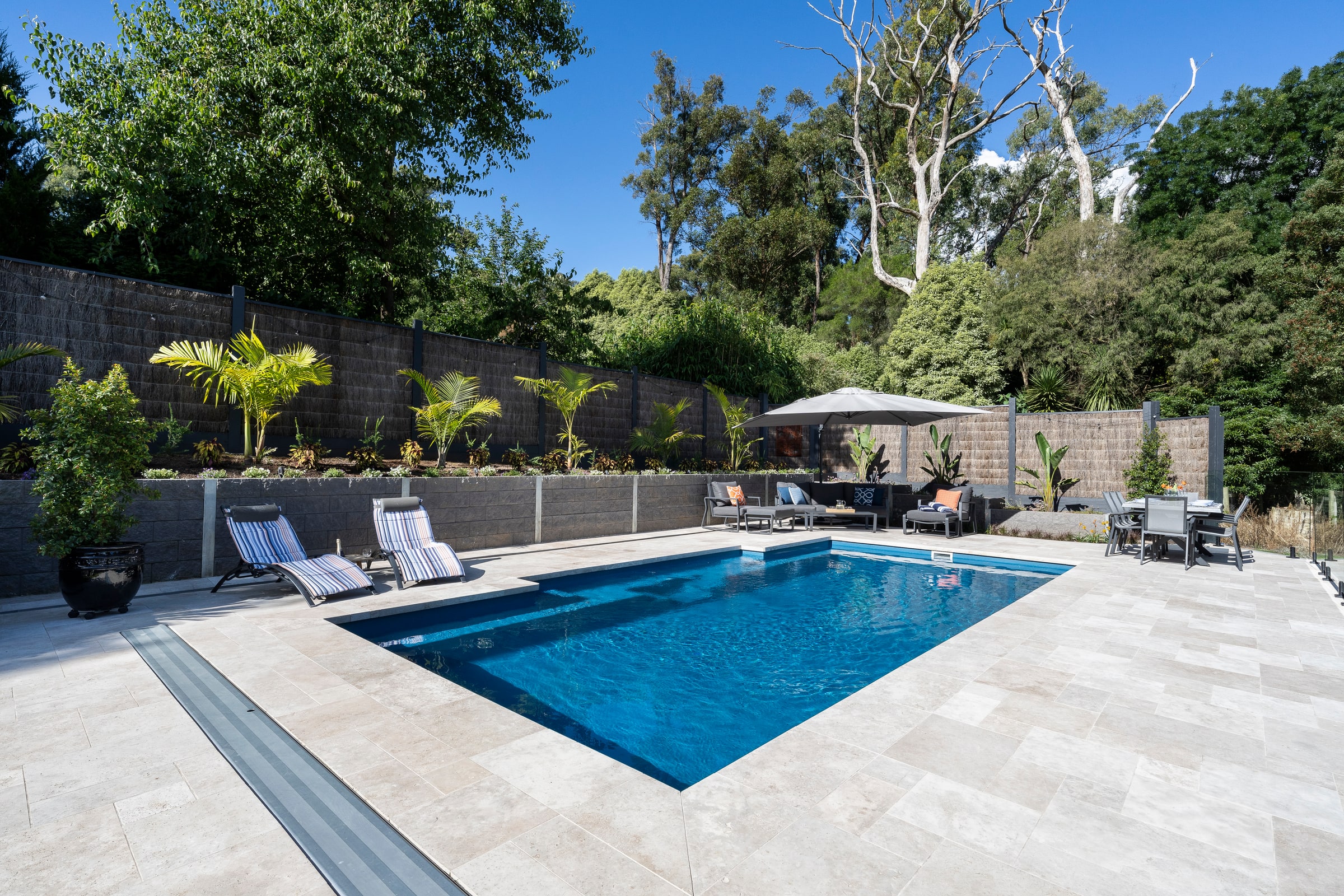 Bluestone-toned fibreglass pool set into the hillside in Emerald
