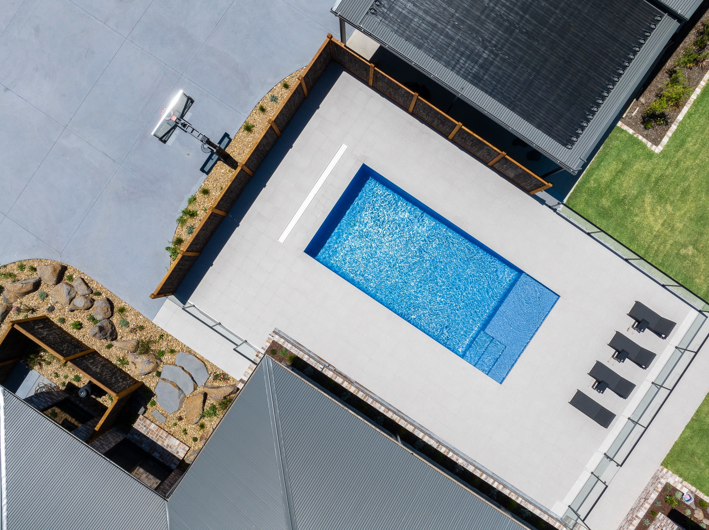 Overhead view of the concrete pool and paved surround in Cranbourne