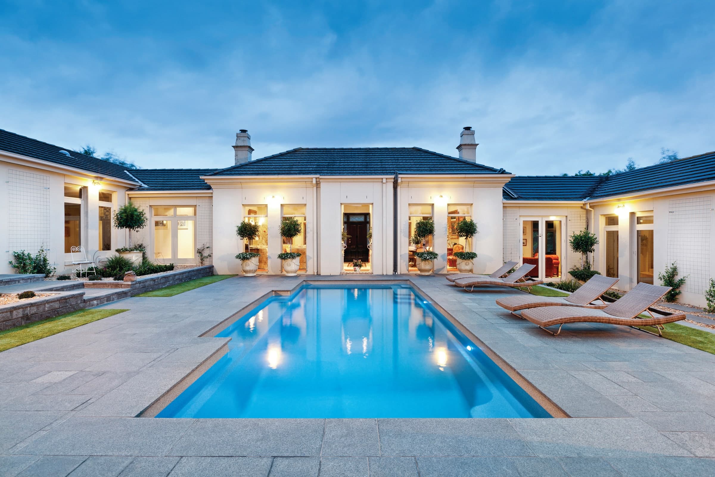 Vogue fibreglass pool centred in a formal paved courtyard