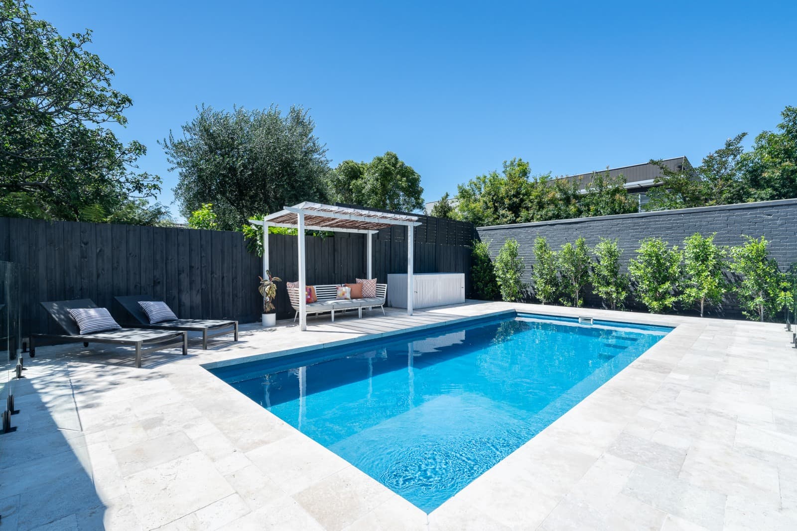 Completed Enchanted Pools fibreglass pool with a shaded seating area