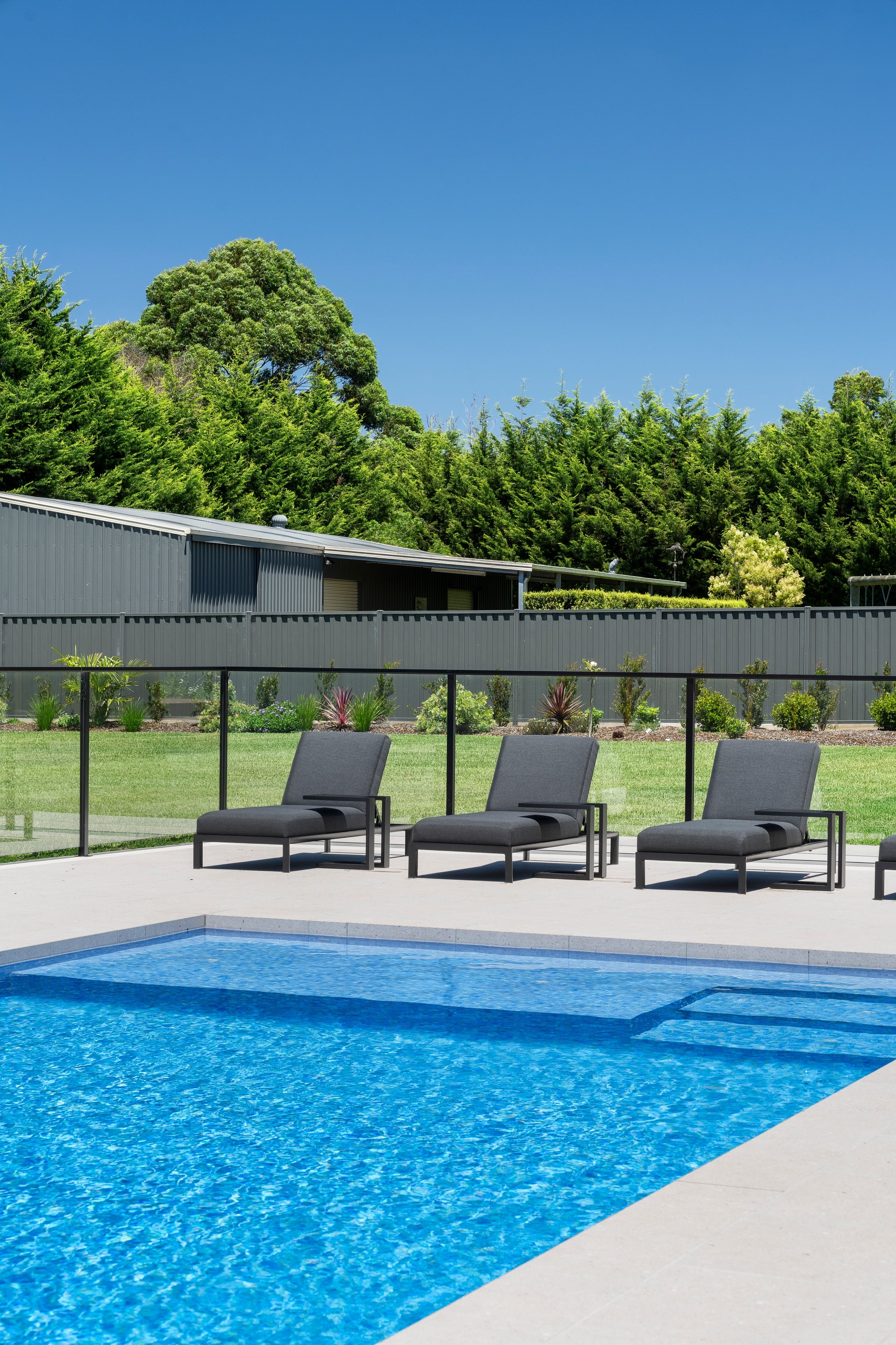 Poolside loungers beside the shallow bench in Cranbourne
