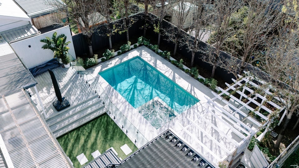 Aerial view of the Bentleigh concrete pool, integrated spa, white pergola and established garden