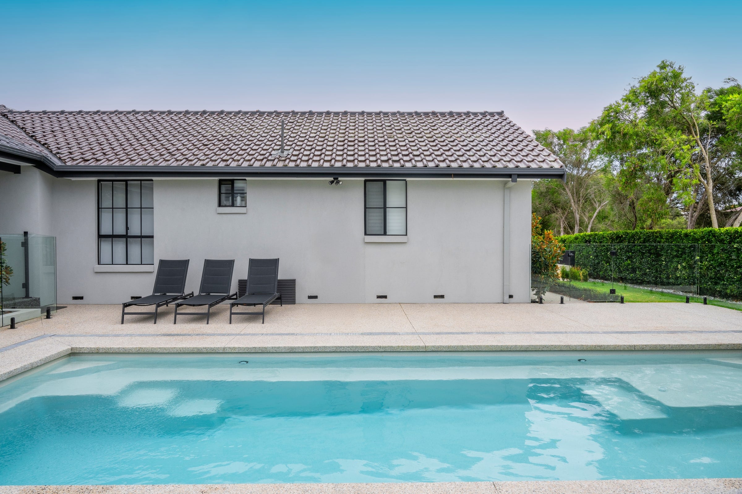 Pearl-finish lap pool beside the family home in Narre Warren North