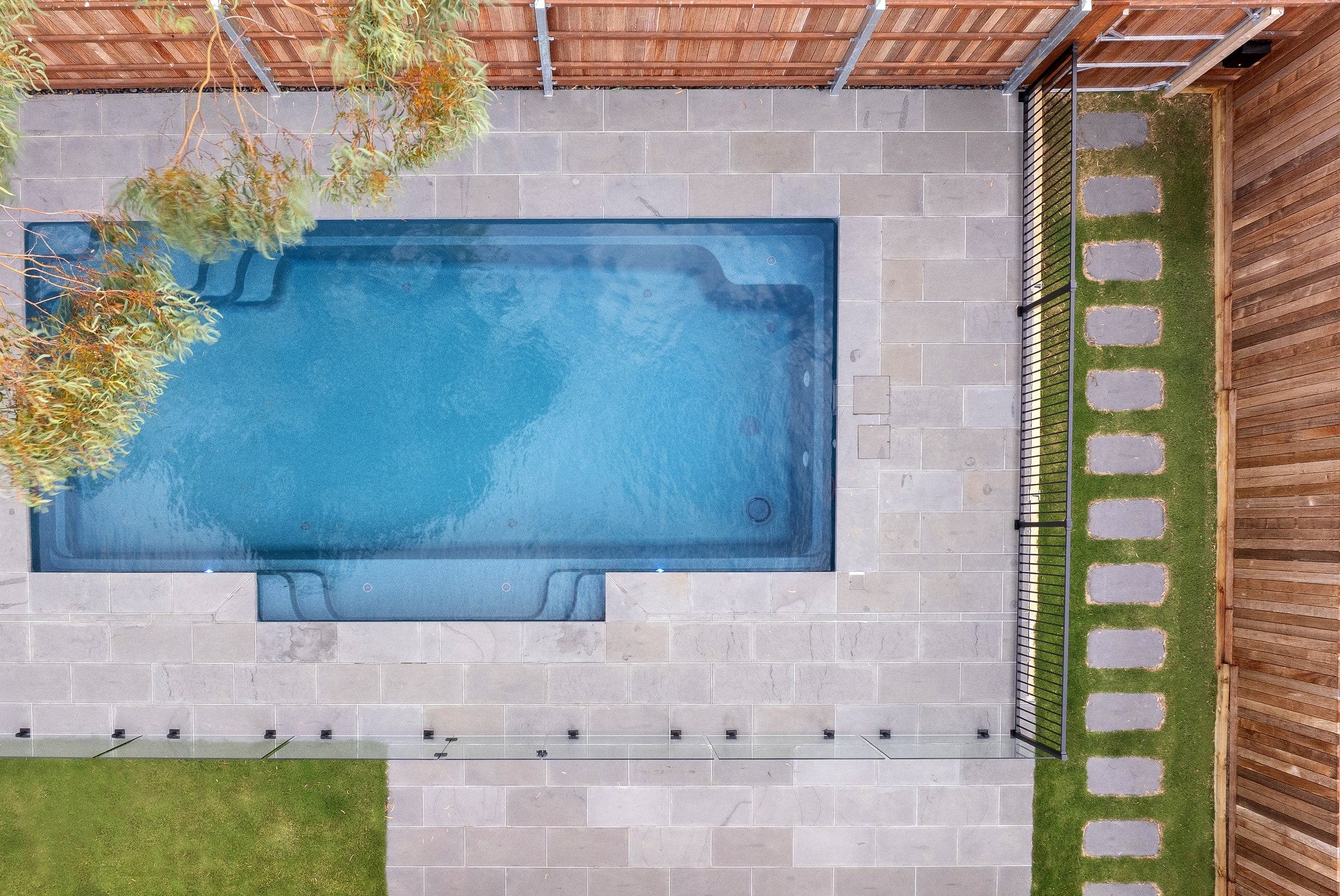 Overhead view of the sapphire pool, bluestone paving and gum tree canopy in Berwick
