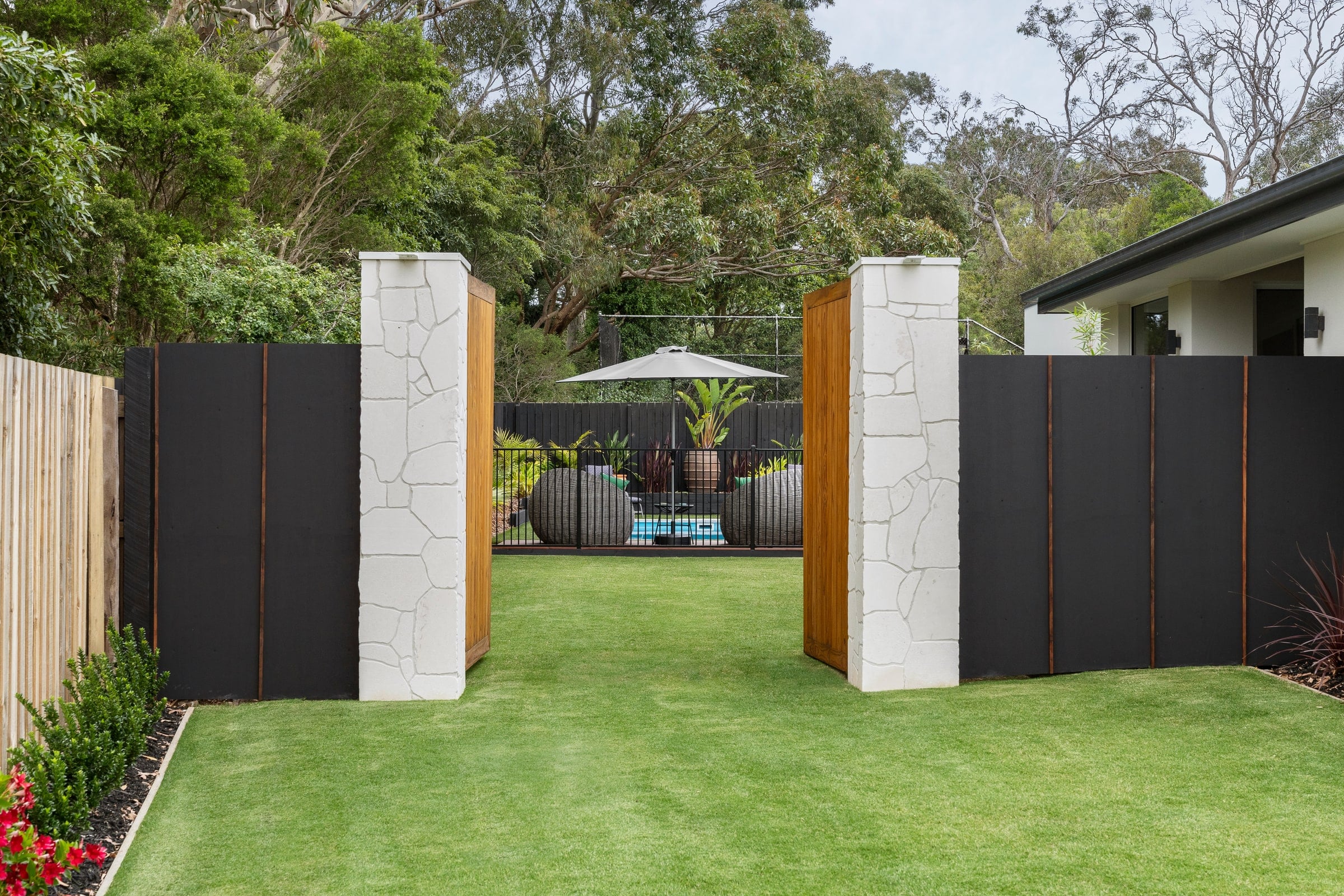 Landscaped garden entrance leading to the pool in Frankston South