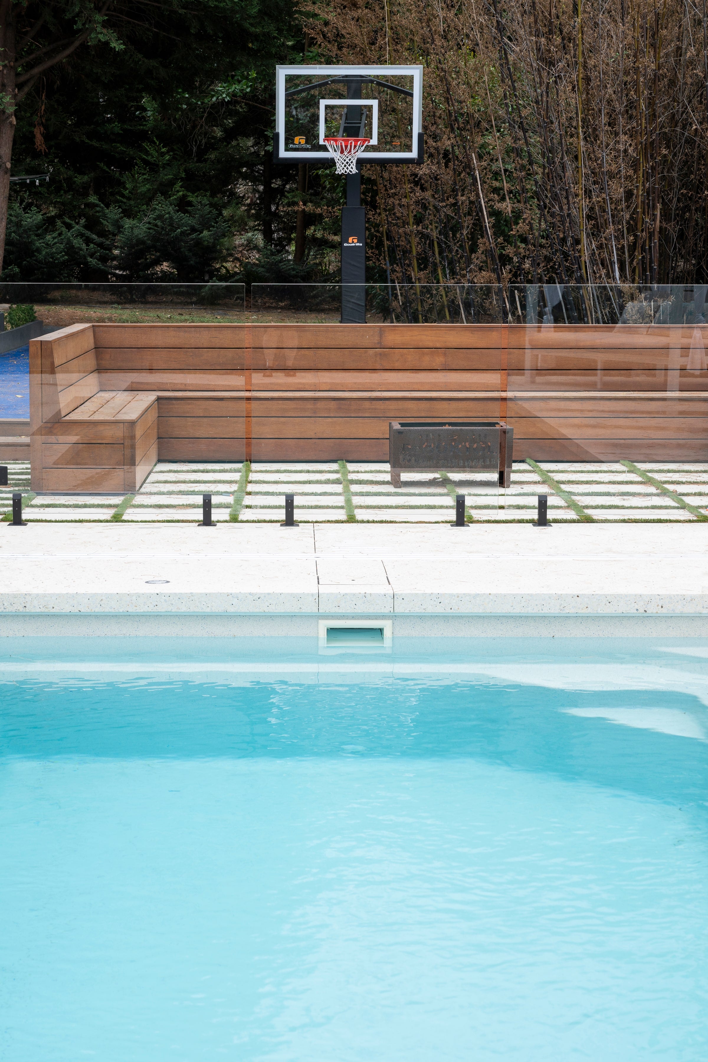 Pool, timber bench seating and basketball court in Pearcedale