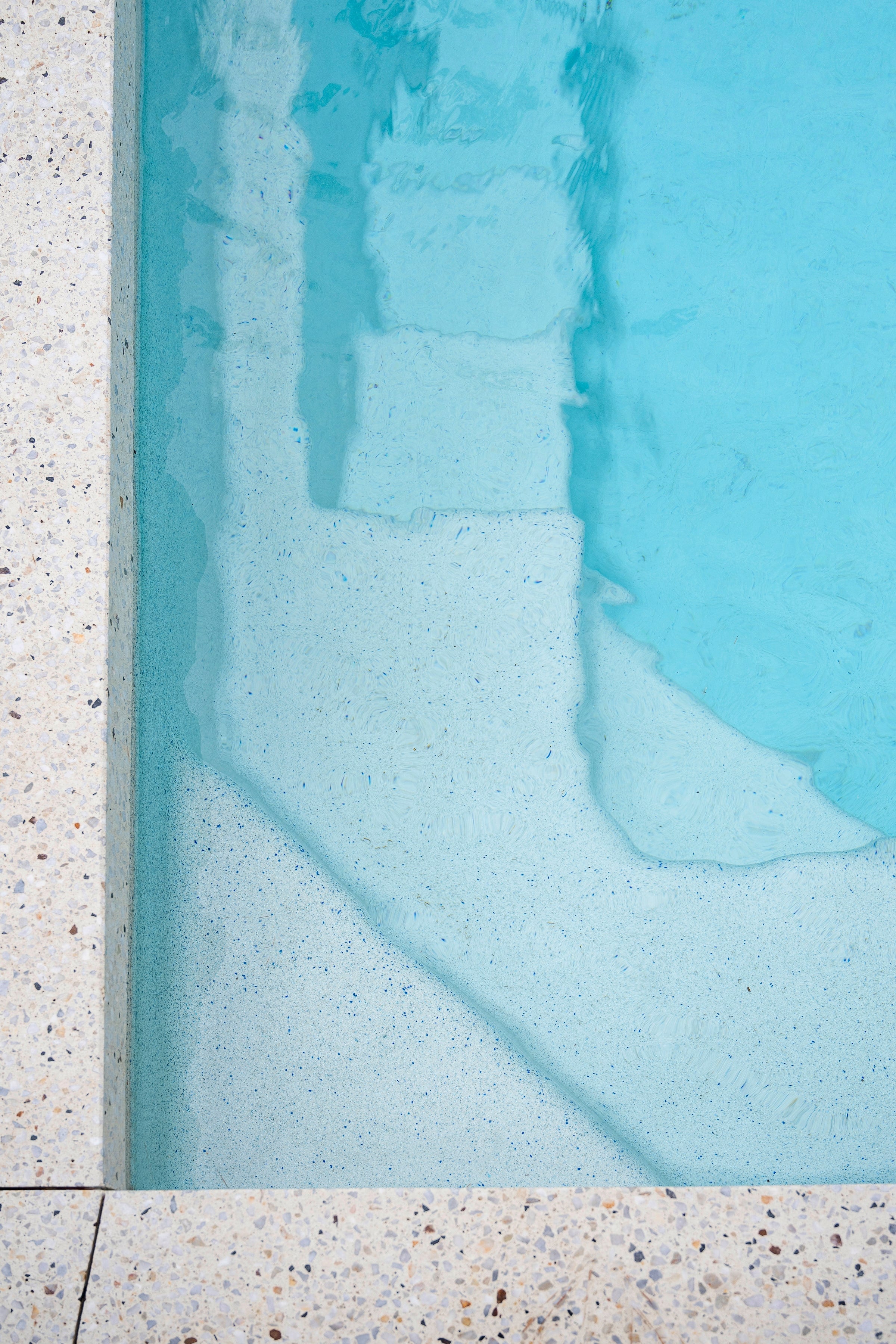Honed terrazzo edge meeting the Pearl pool interior in Pearcedale